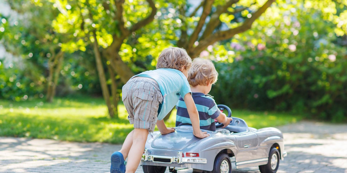 Two employees standing in front of their coffee shop